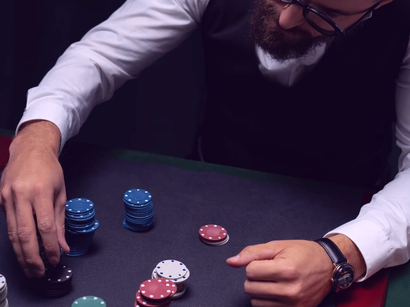A hand pausing mid-roll with a pair of dice over the table