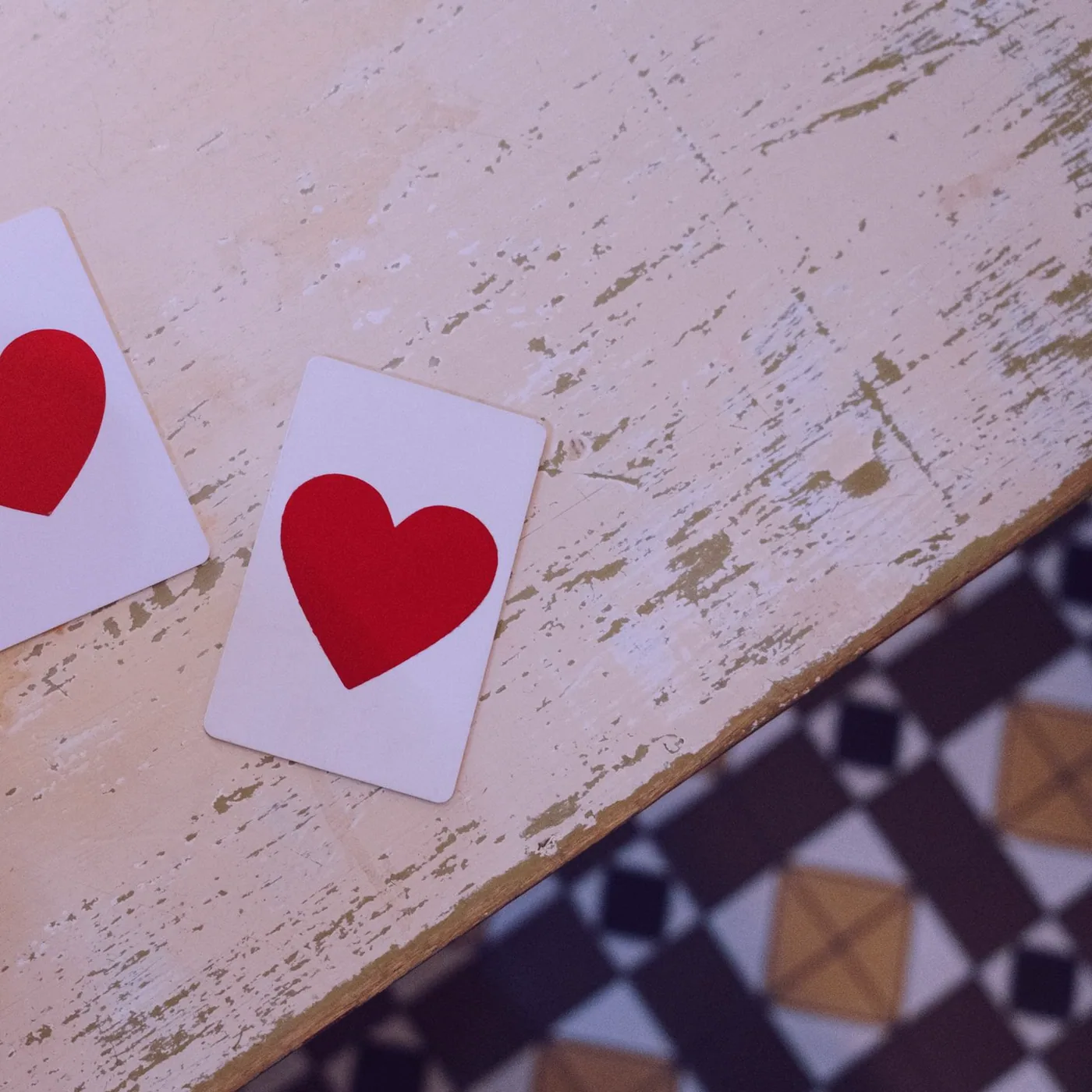 Two hearts face up beside the service bell on the counter table