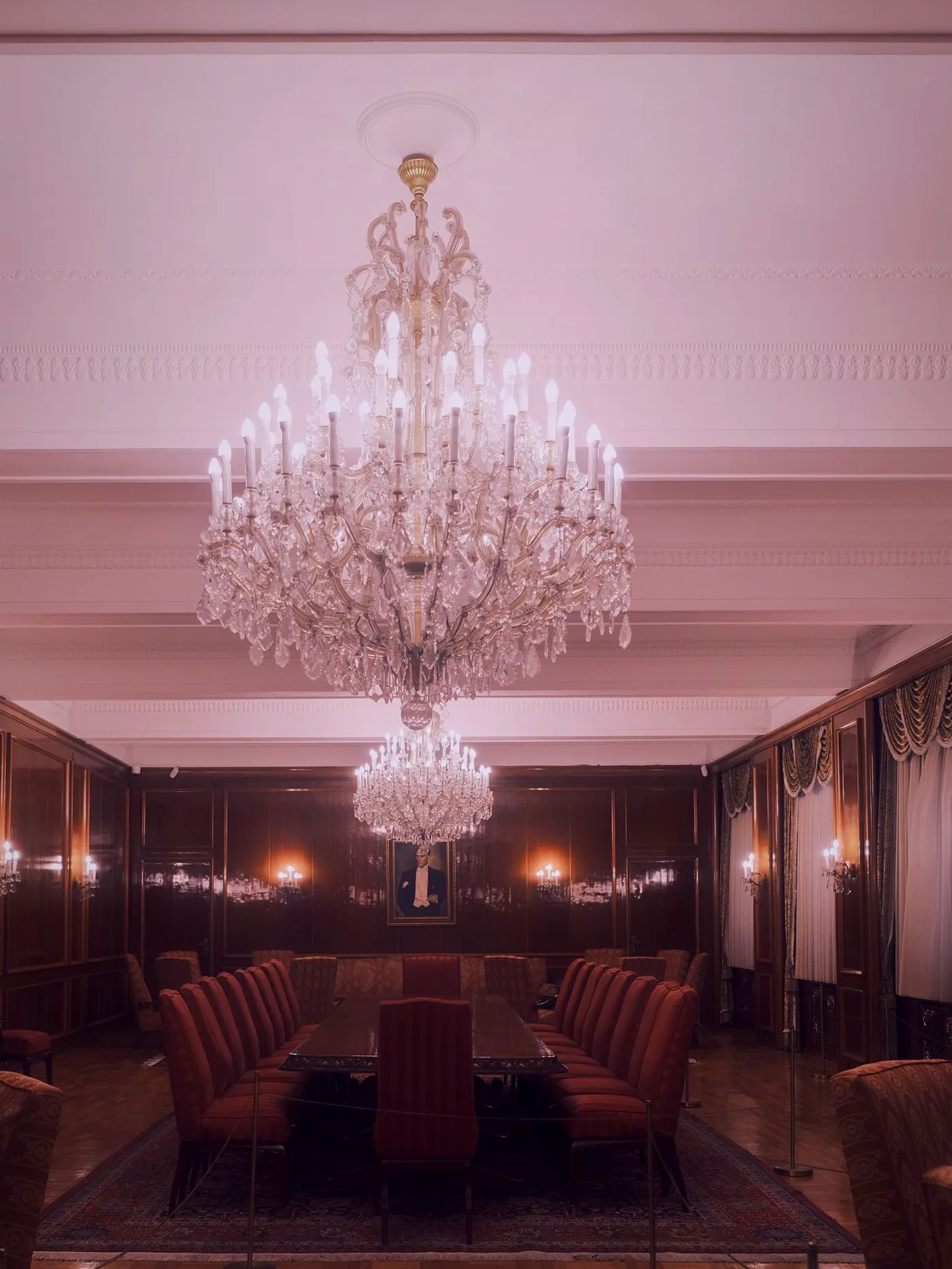 The chandelier and panelled hall lit for the evening